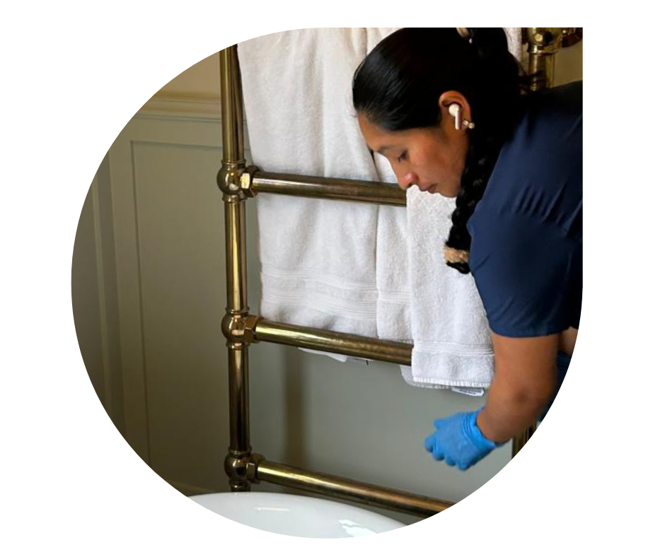 Royal Glow Cleaning professional sanitizing a bathroom in a San Francisco Bay Area home using health-conscious cleaning practices