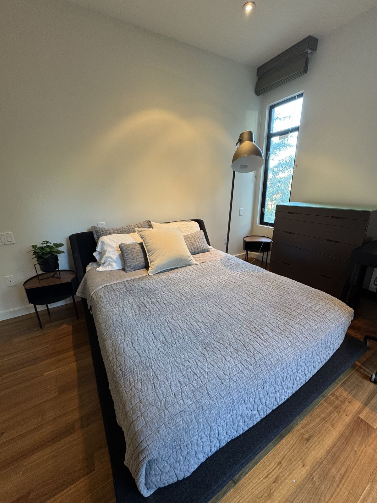 Freshly made bed in a San Bruno bedroom cleaned by Royal Glow Cleaning