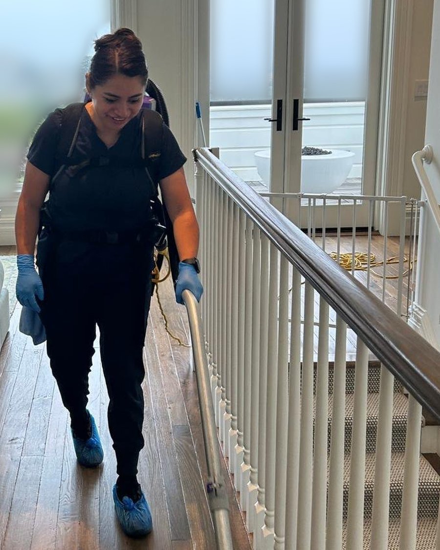 Royal Glow Cleaning team member cleaning a staircase