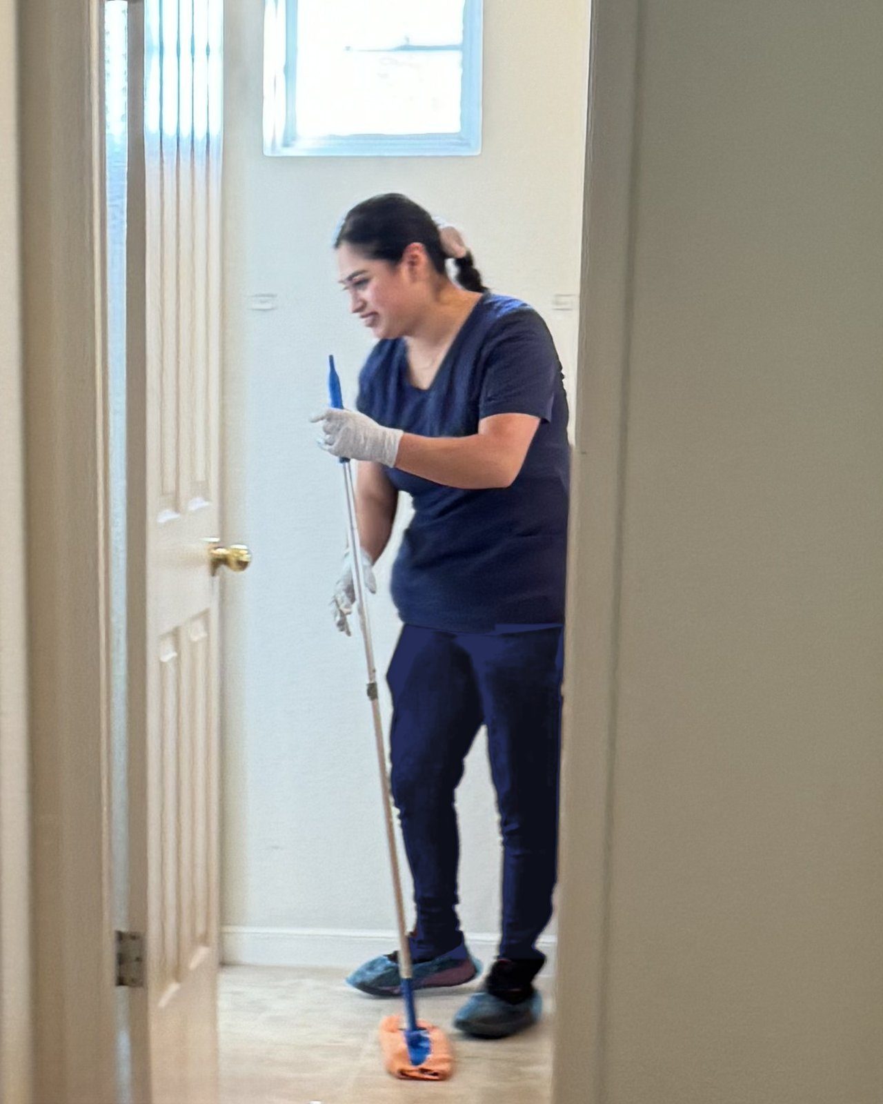 Royal Glow cleaner mopping a hallway before move-in